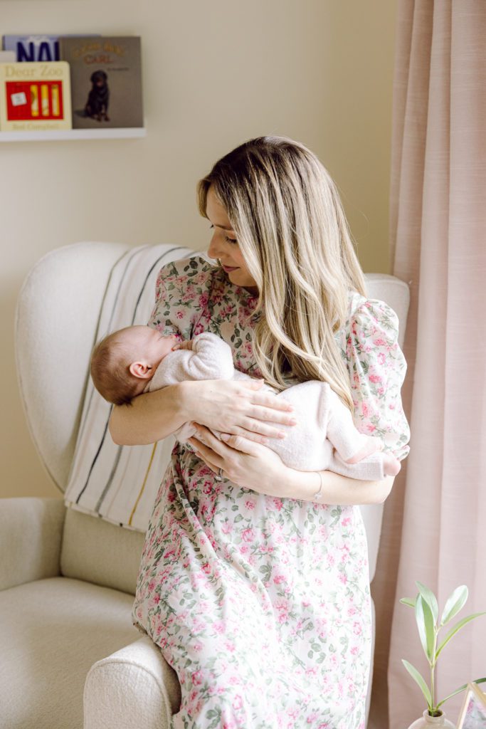 Mom in pink floral dress holding baby
