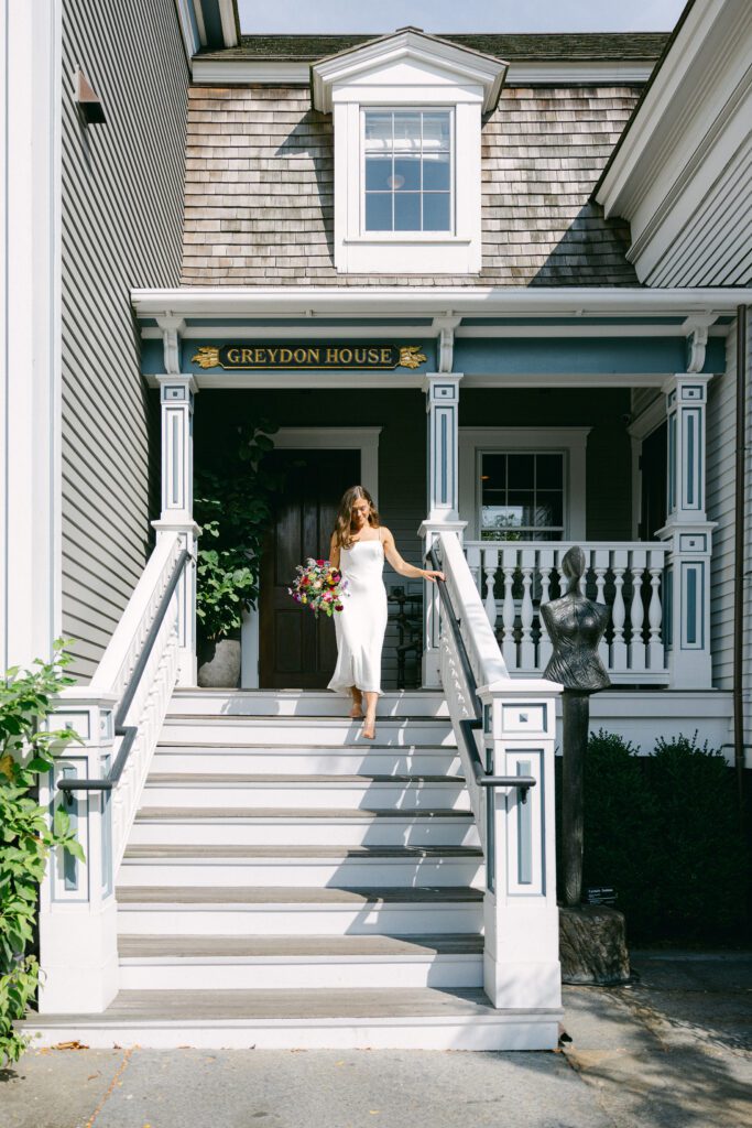Bride walking down stairs of Greydon House Nantucket hotel to first look.