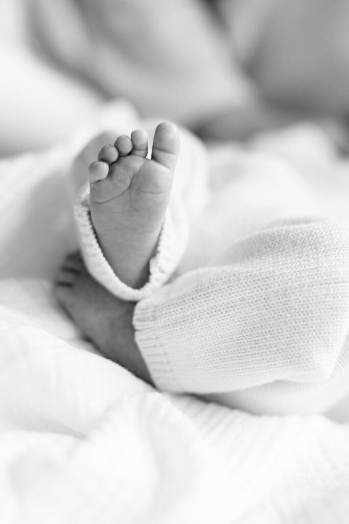 Black and white image of newborn baby's feet.