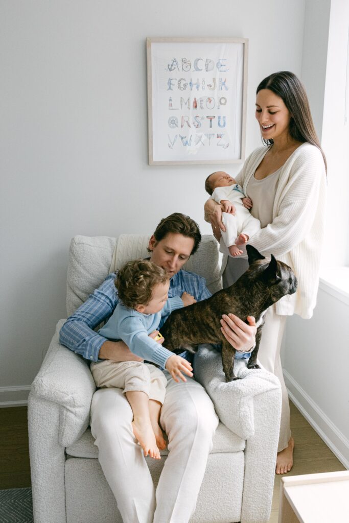 Family of four plus their dog enjoy each other's company in their New York apartment.
