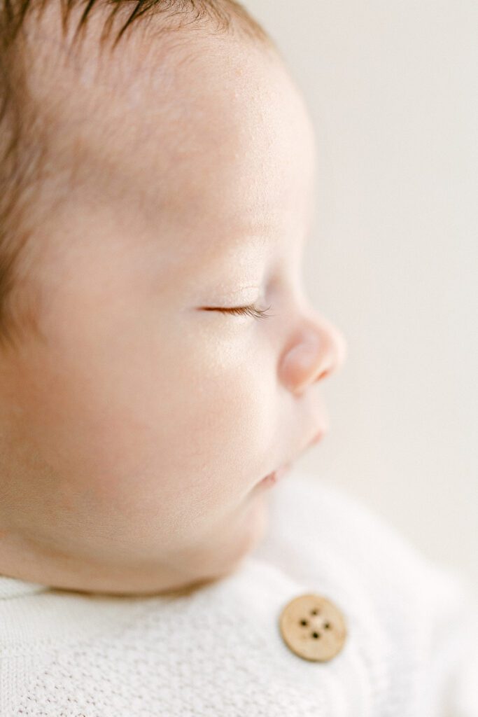 Close-up profile shot of newborn baby's face while sleeping. 