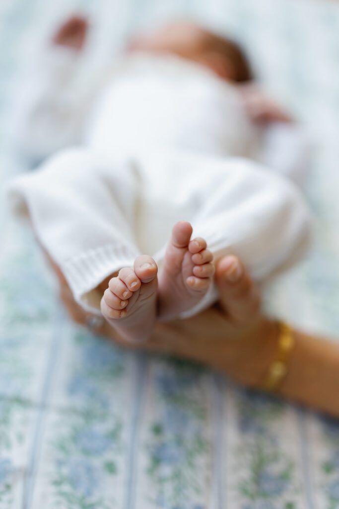 A newborn baby's feet are being held up by mom at home in the Connecticut suburbs. 